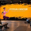 Tranh dán tường phòng gym fitness FitFun Center với thiết kế nền cam đen nổi bật